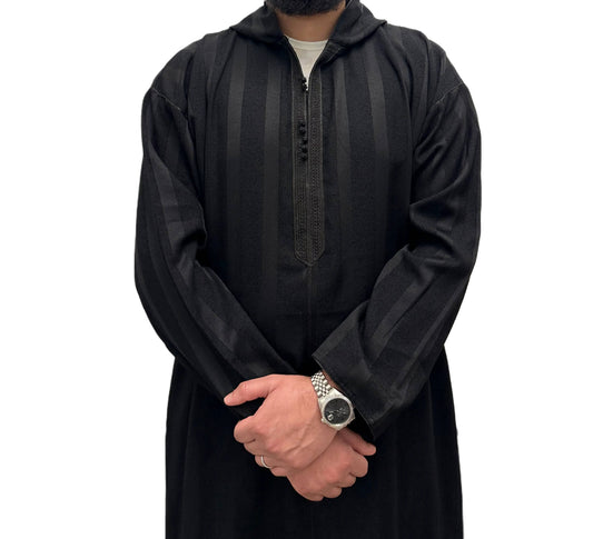 Hooded Moroccan djellaba, front view in black with dark vertical stripes.