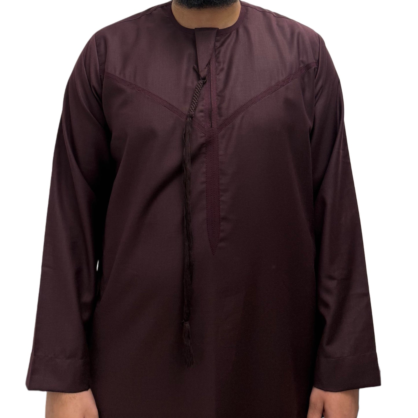 Model standing with hands by his side wearing a Burgundy Omani thobe, minimalist design with clean tailoring