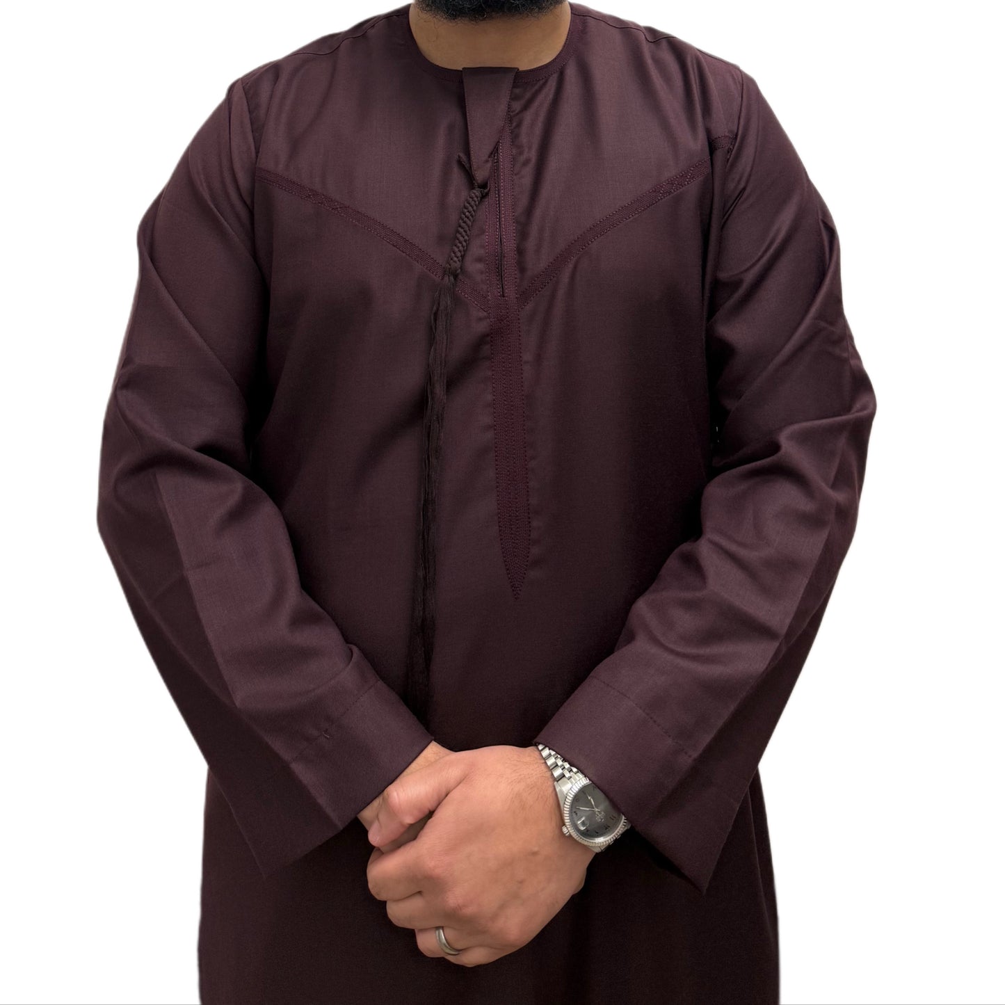 Man wearing a plain Burgundy Omani thobe with hands crossed, featuring a relaxed fit and traditional tassel detail