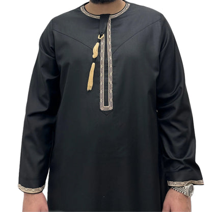 Black embroidered Omani thobe with gold detailing on neckline and zip from a front view.