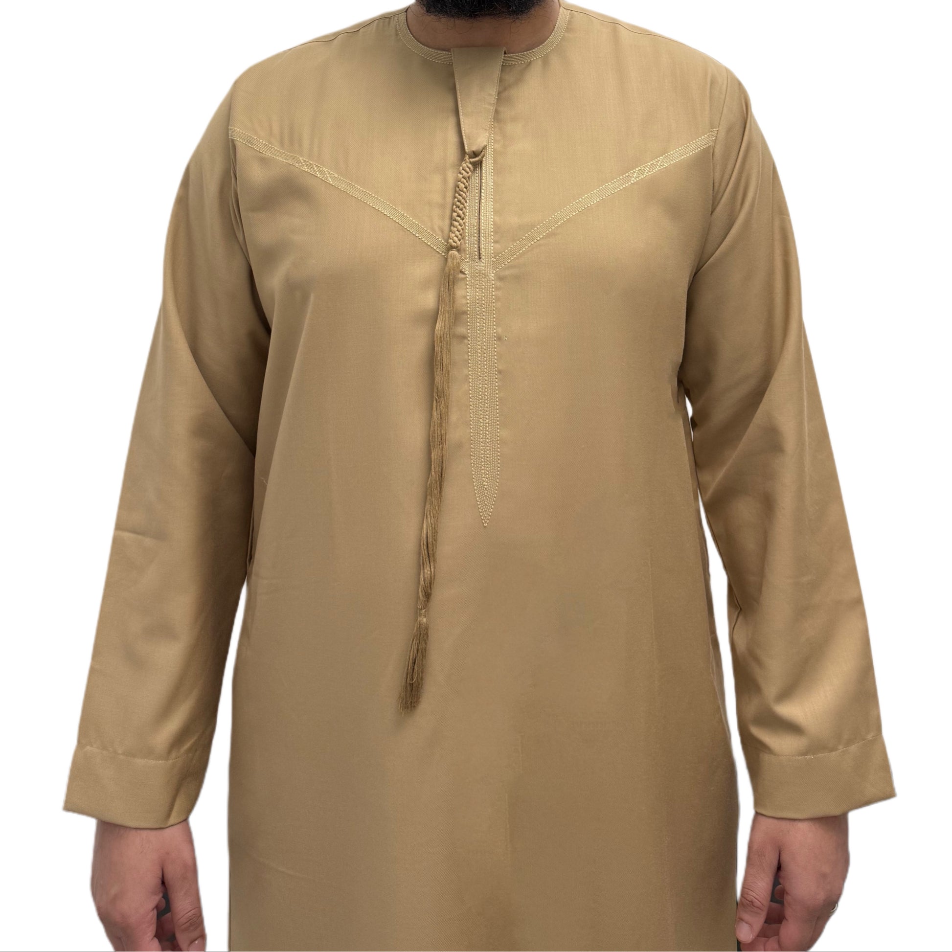 Model standing with hands by his side wearing a Beige Omani thobe, minimalist design with clean tailoring